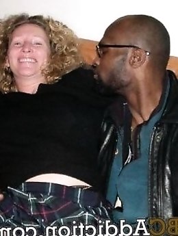 Hot MILF Stella in a white dress and black pantyhose showcasing her seductive charm