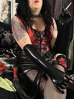 The mistress is smoking a cigar and using a strapon