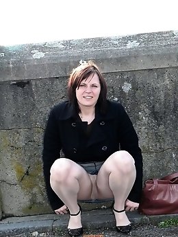 A provocative older woman poses partially nude in a collection of explicit images.